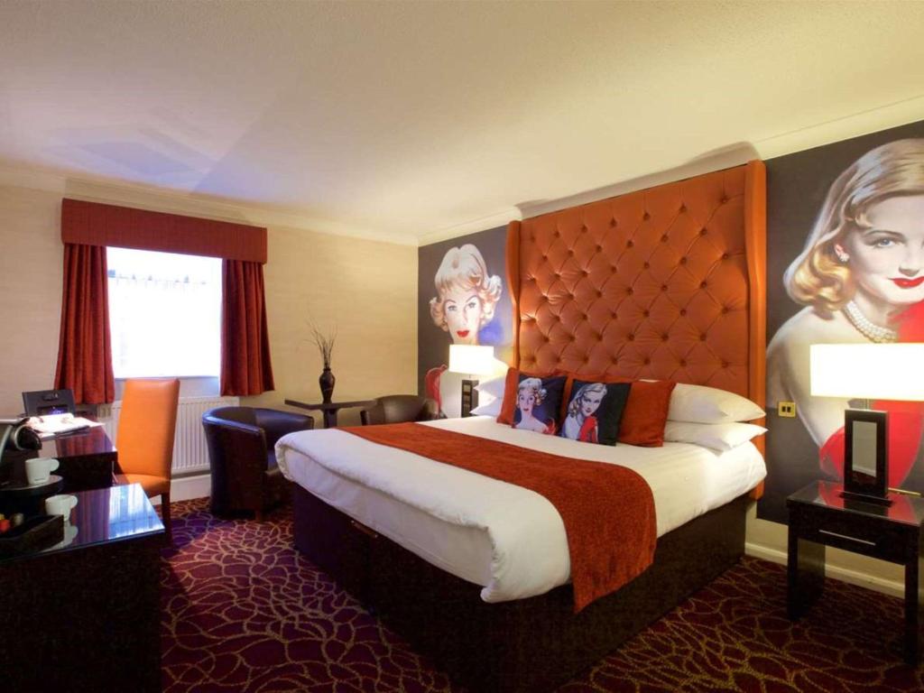 a hotel room with a large bed with a large headboard at Preston Leyland Hotel, BW Signature Collection in Preston