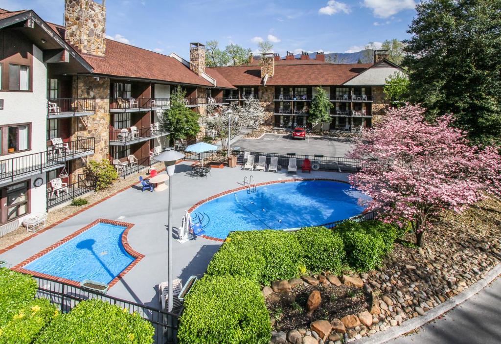 a house with a pool and a balcony at River Edge Inn in Gatlinburg