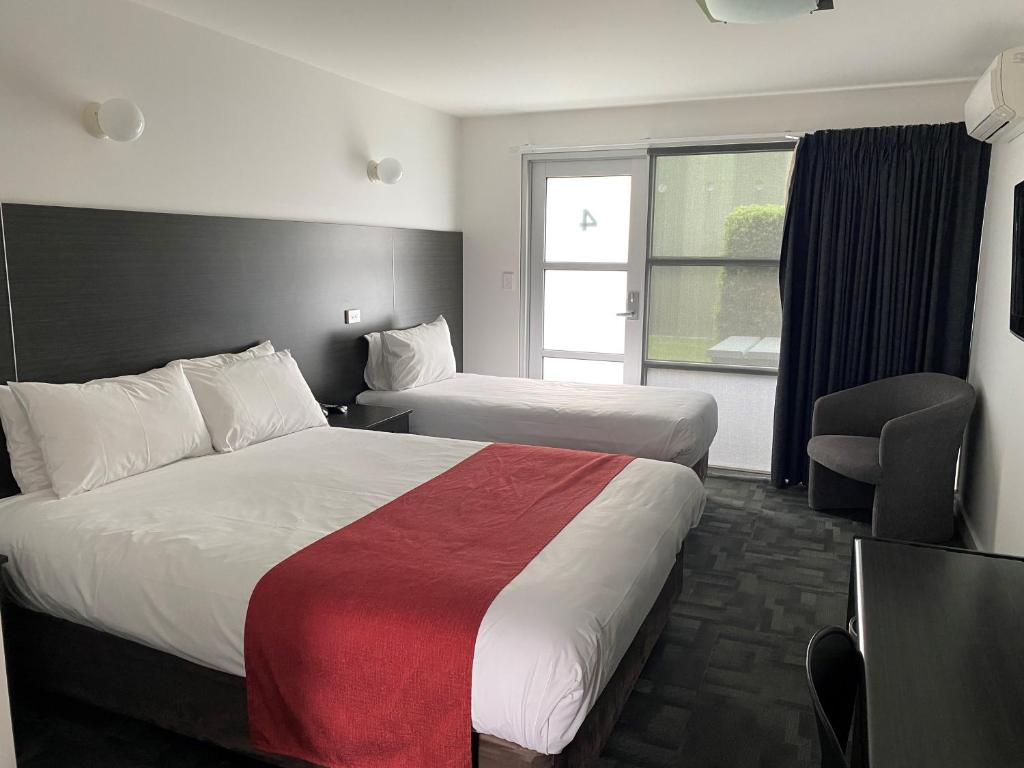 Postel nebo postele na pokoji v ubytování Brighton Hotel Motel