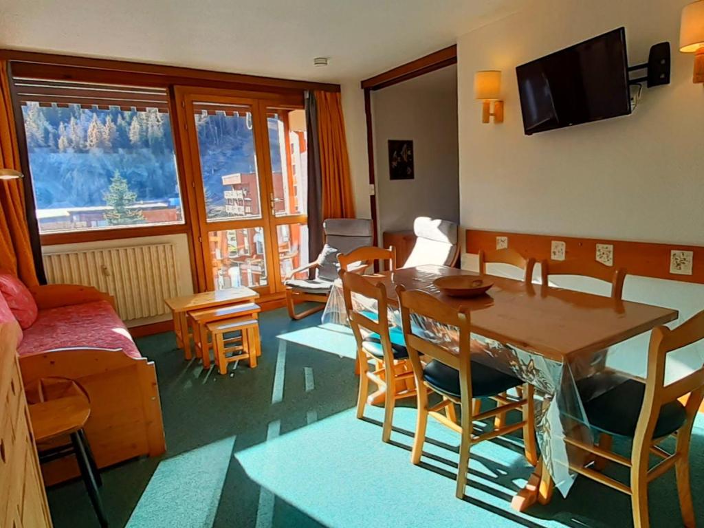 a room with a table and chairs and a living room at Appartement La Plagne, 3 pièces, 6 personnes - FR-1-351-2 in La Plagne