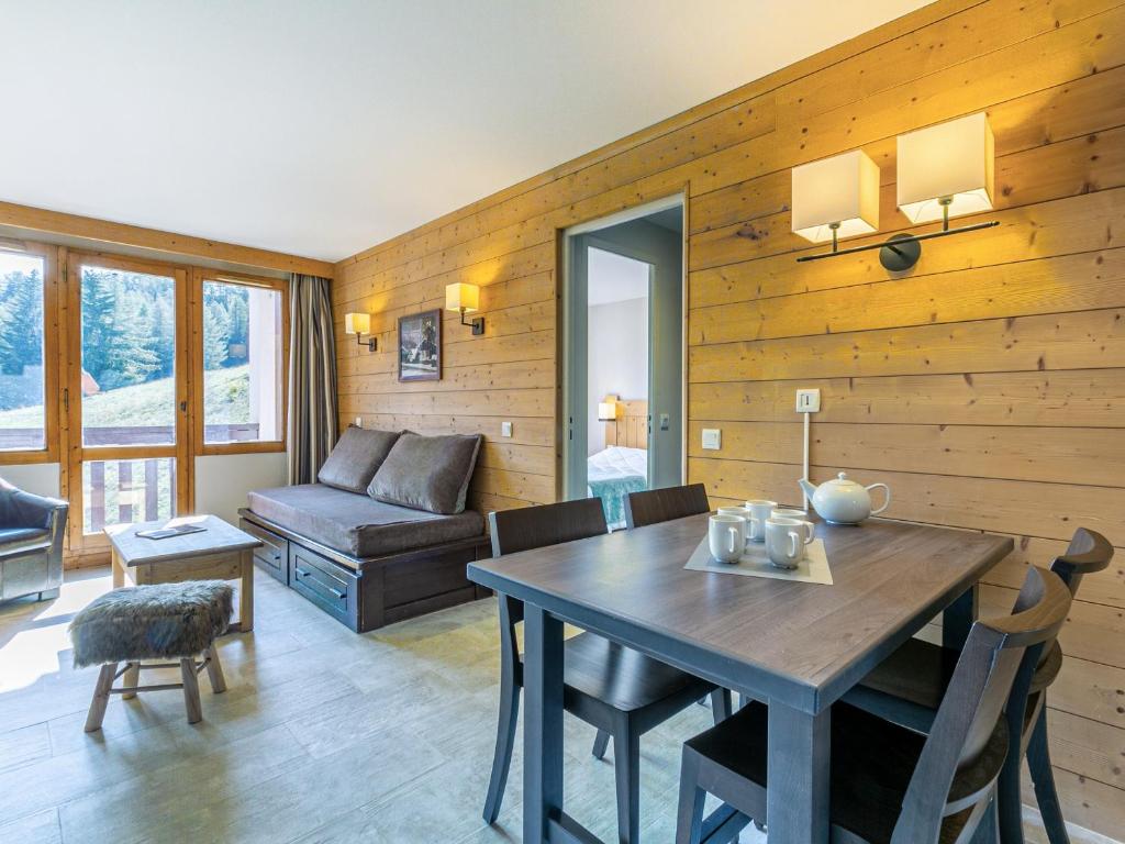 a living room with a table and a couch at Appartement La Plagne-Tarentaise, 2 pièces, 5 personnes - FR-1-353-81 in Montchavin