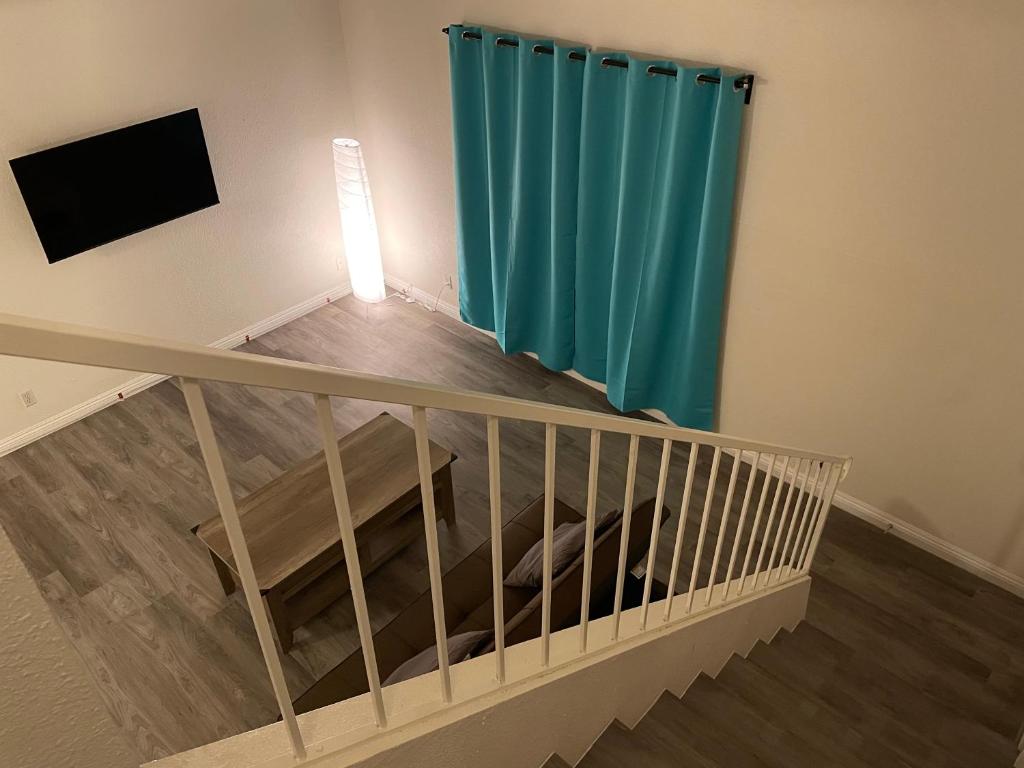 a room with a staircase with a green curtain at Golden Vegas Condo next to Airport & University in Las Vegas