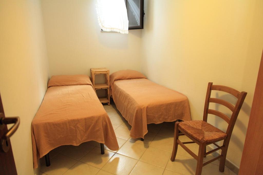 A bed or beds in a room at Case Gabbiano (by Vacation Service)