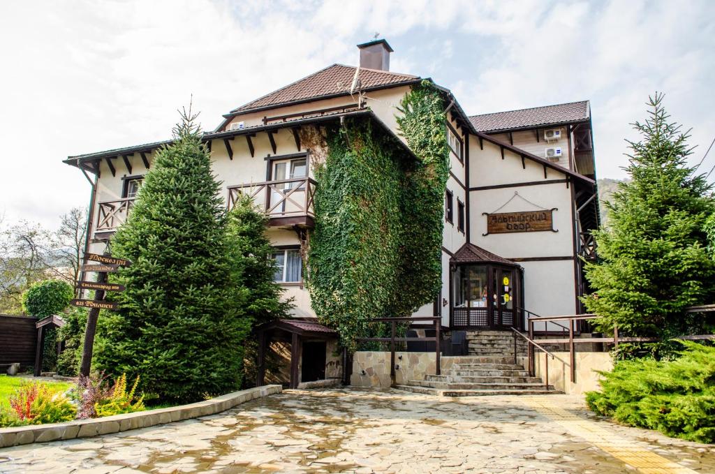 a house with ivy on the side of it at Alpiysky Dvor in Krasnaya Polyana