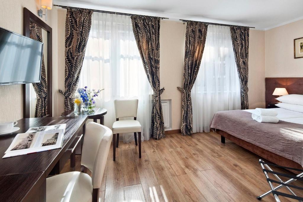 Postel nebo postele na pokoji v ubytování Hotel Bonum Old Town