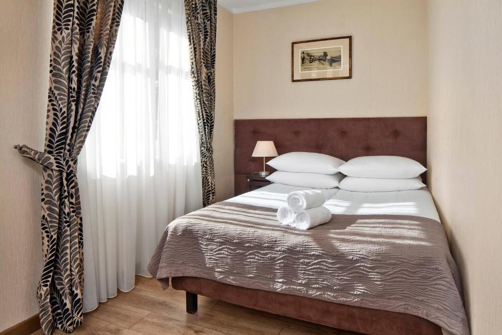 Postel nebo postele na pokoji v ubytování Hotel Bonum Old Town