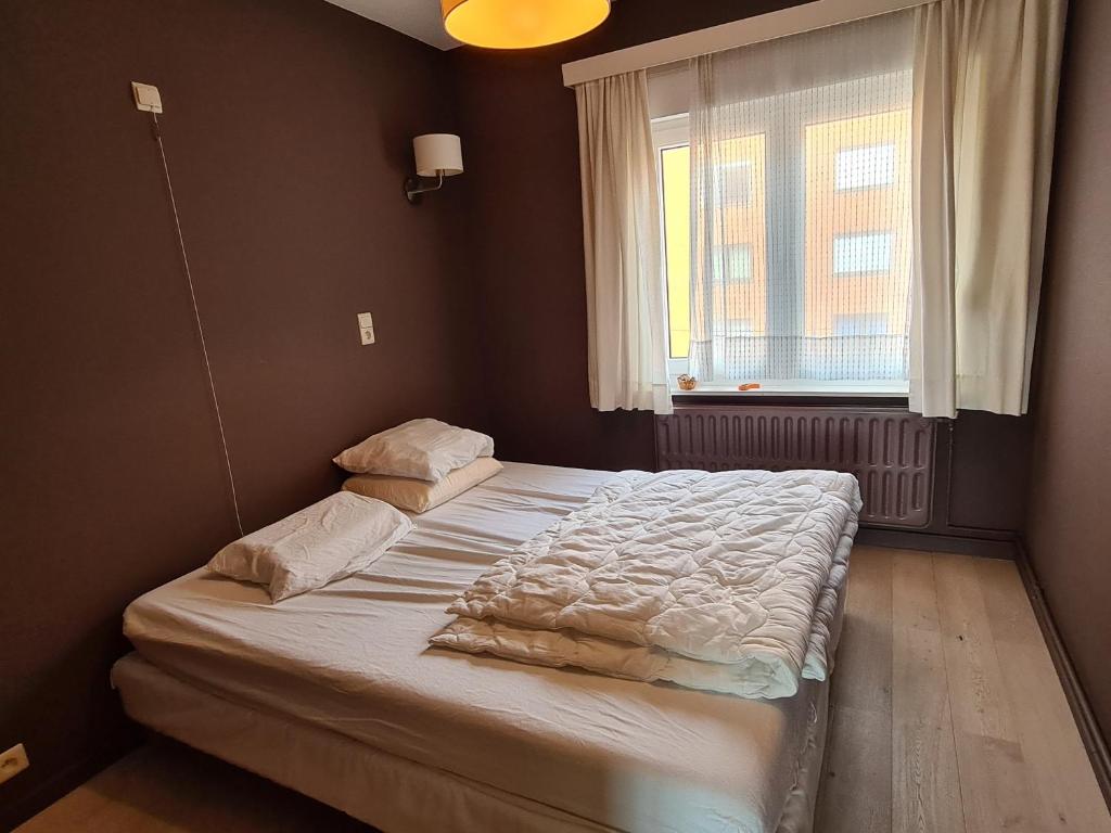 Postel nebo postele na pokoji v ubytování Oostduinkerke Apartments
