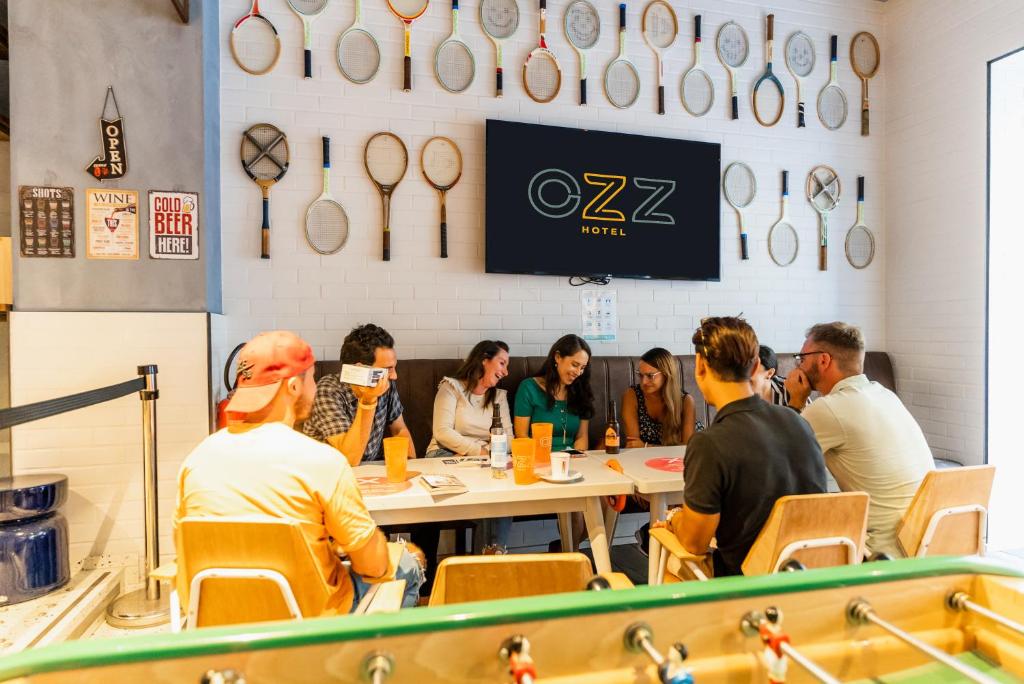a large group of people sitting at a counter at Hôtel Ozz by Happyculture in Nice