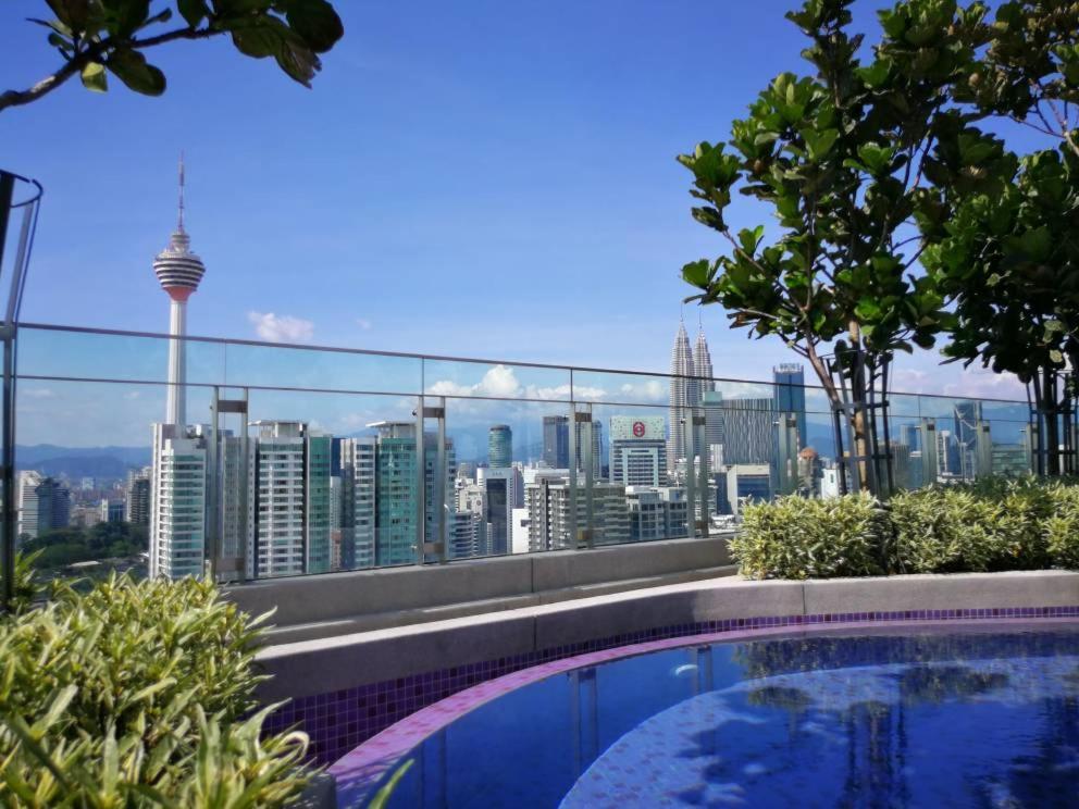 a swimming pool on top of a building with a city skyline at Maxhome@ Robertson Residence suite, KL Bukit Bintang. in Kuala Lumpur