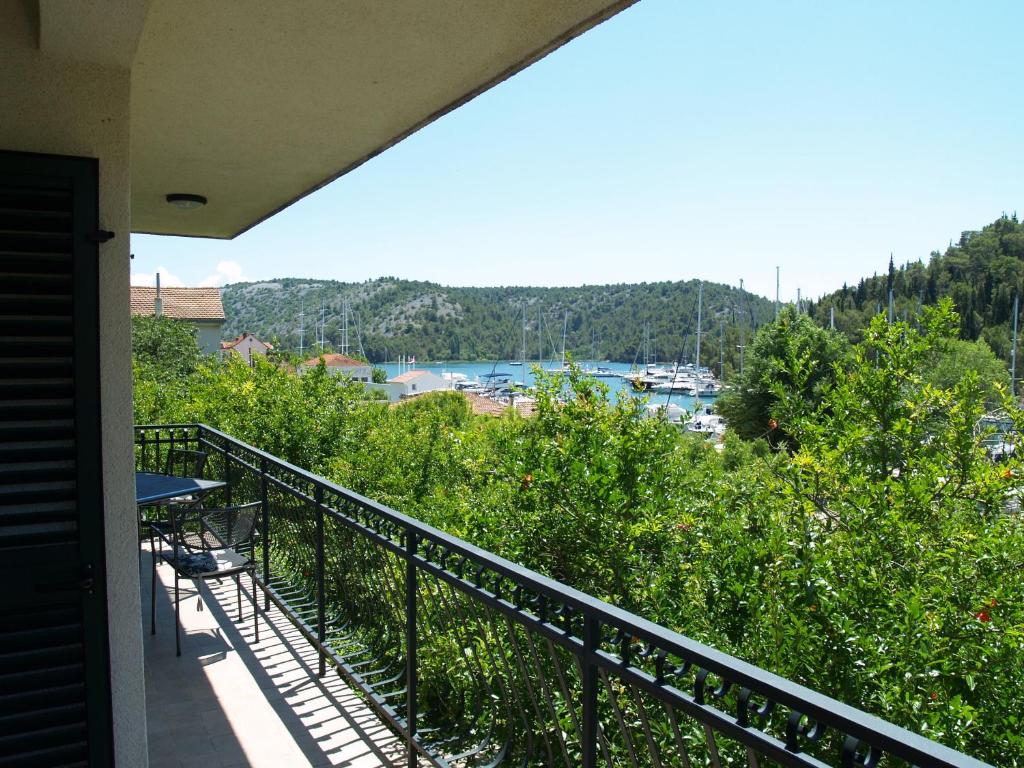 a balcony of a house with a view of a harbor at Apartments & Rooms Formenti in Skradin