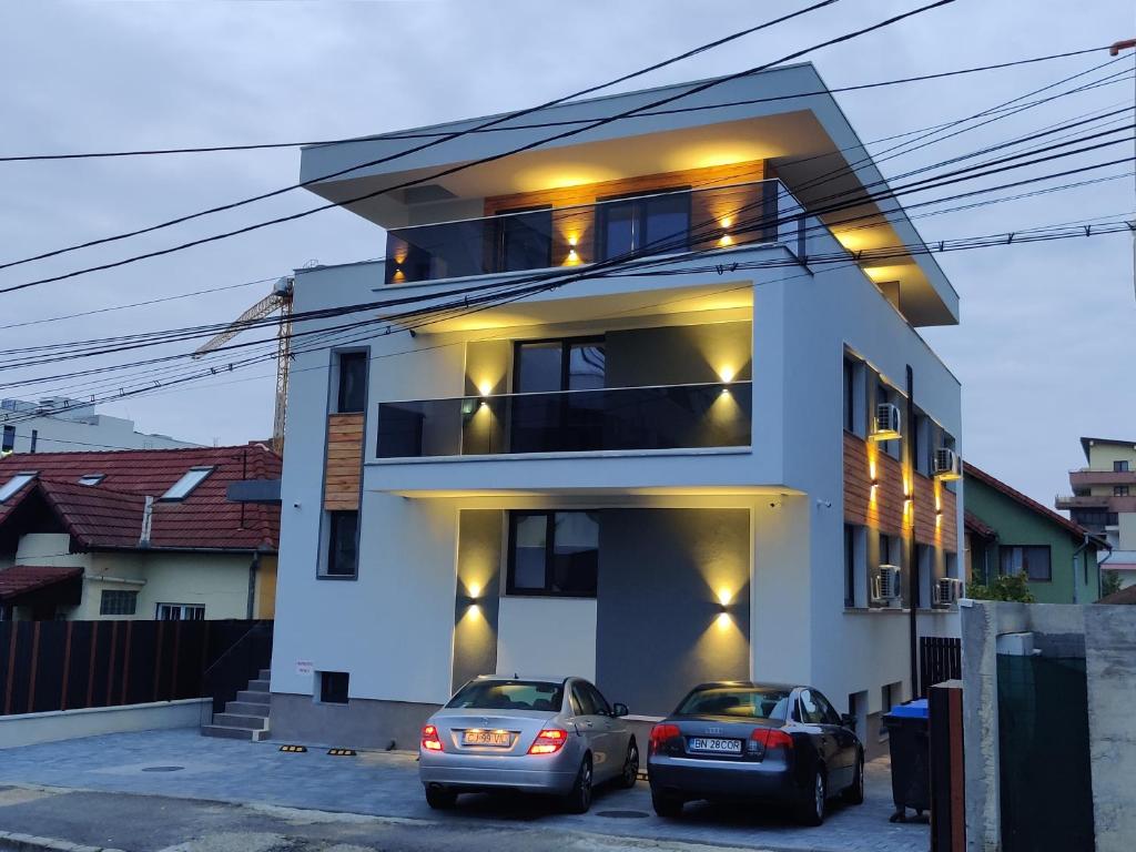 two cars parked in front of a house at SarmiHouse in Cluj-Napoca