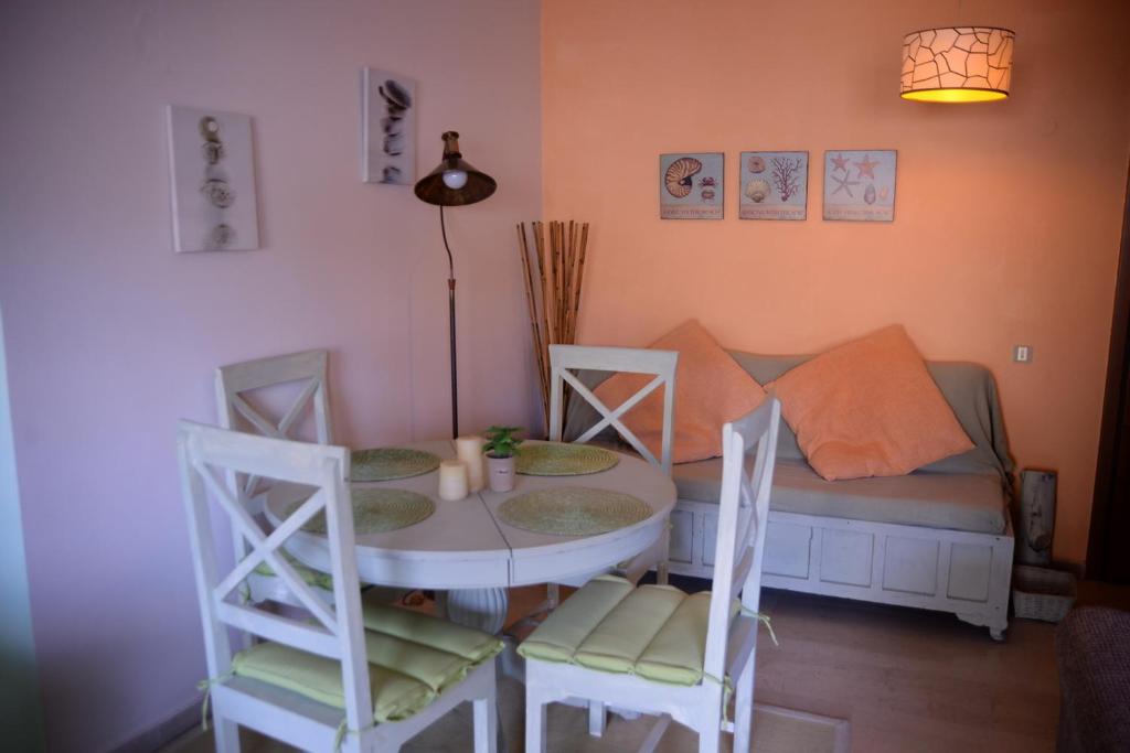 a room with a table and chairs and a couch at Dream house in Loutraki