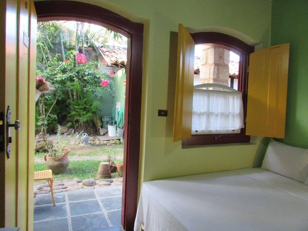 Postel nebo postele na pokoji v ubytování Pousada Solar do Algarve em Paraty há 5 minutos do Centro Histórico