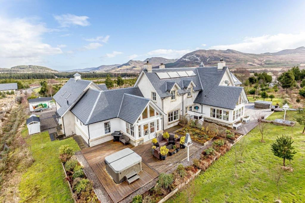 an aerial view of a large white house at Glenerrick House - Loch Ness country manor - hot tub and sauna in Whitebridge