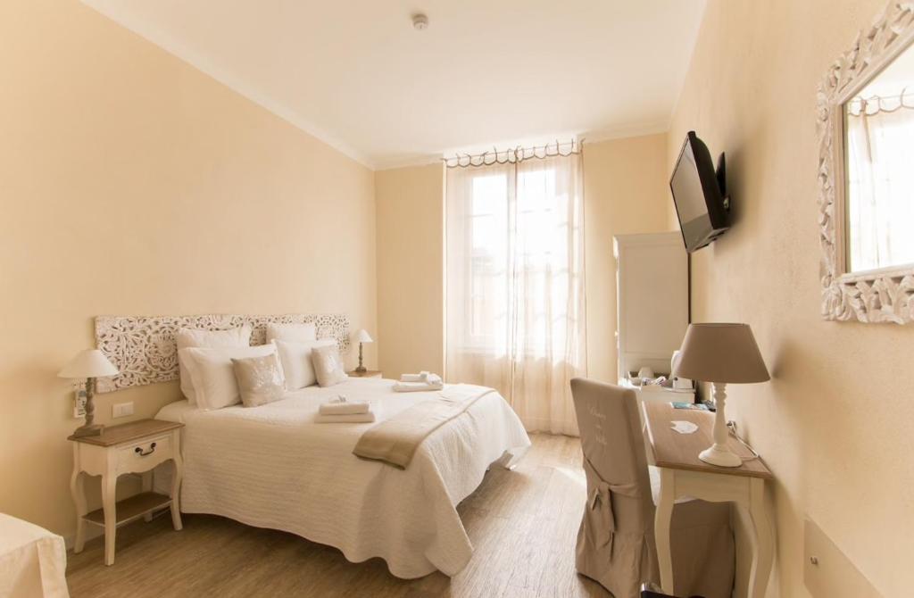 Dormitorio con cama, escritorio y TV en Affittacamere Casa Dane', en La Spezia