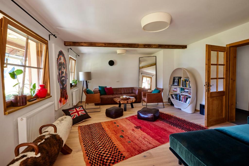 a living room with a couch and a table at Frein Chalets - Wildalm in Frein