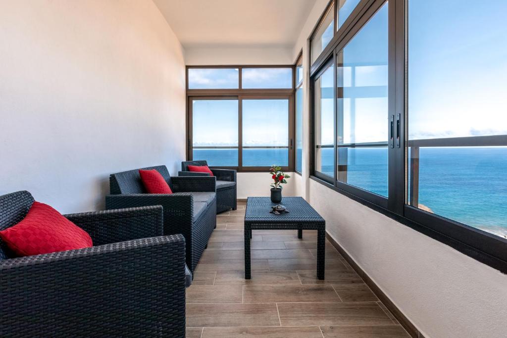 a living room with two couches and a table at Anaga Ocean Views (A): Mountain and Beach Retreat in Santa Cruz de Tenerife