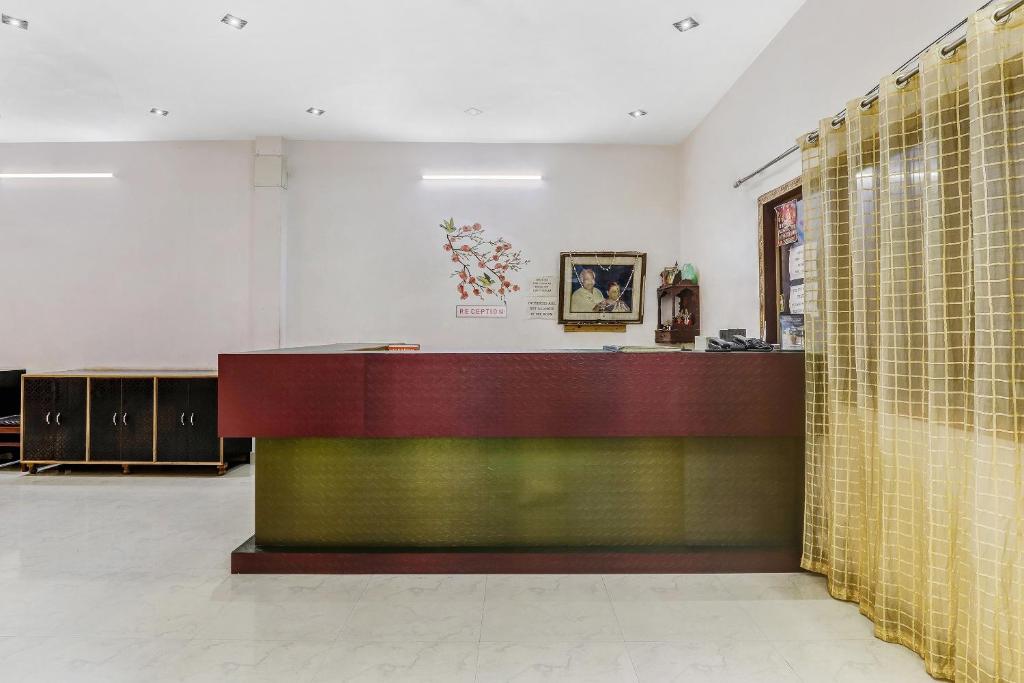 a lobby with a reception desk and tile walls at Hotel K V PALACE in Varanasi