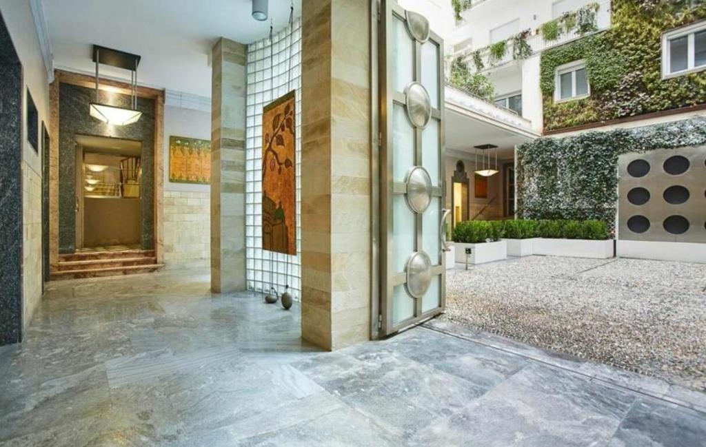 an open door of a building with a courtyard at Palazzo Beltrade in Milan
