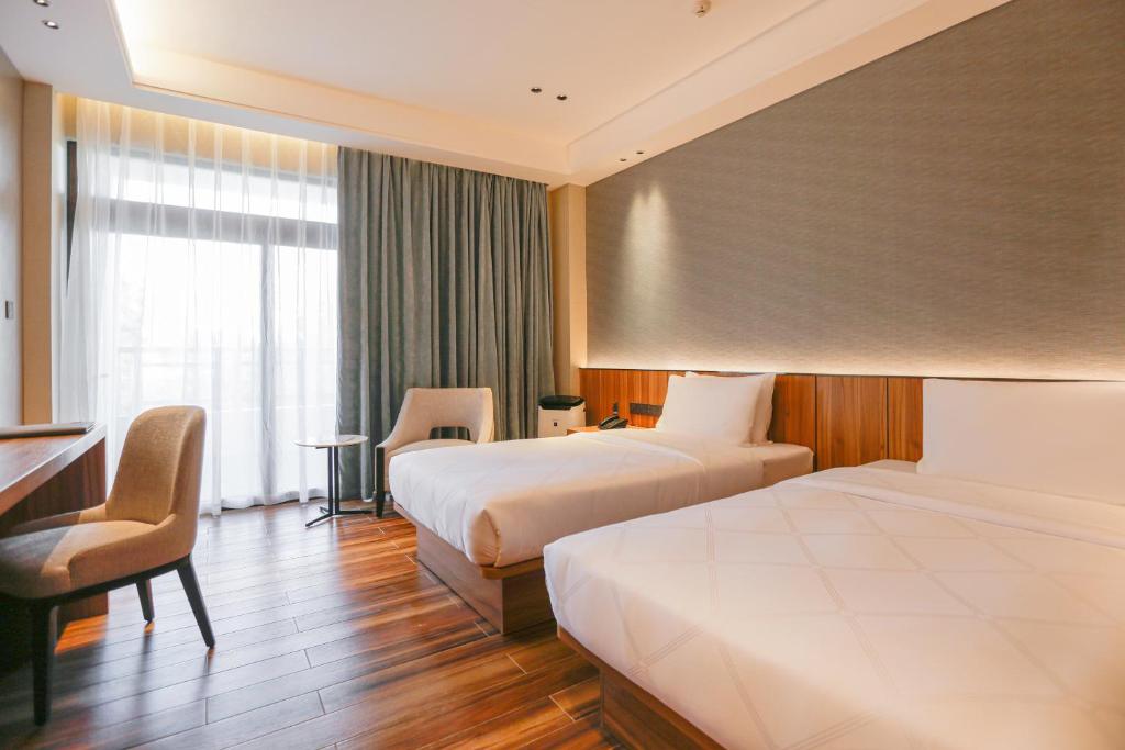 Postel nebo postele na pokoji v ubytování Hotel Casiana & Events Center Tagaytay Managed by HII