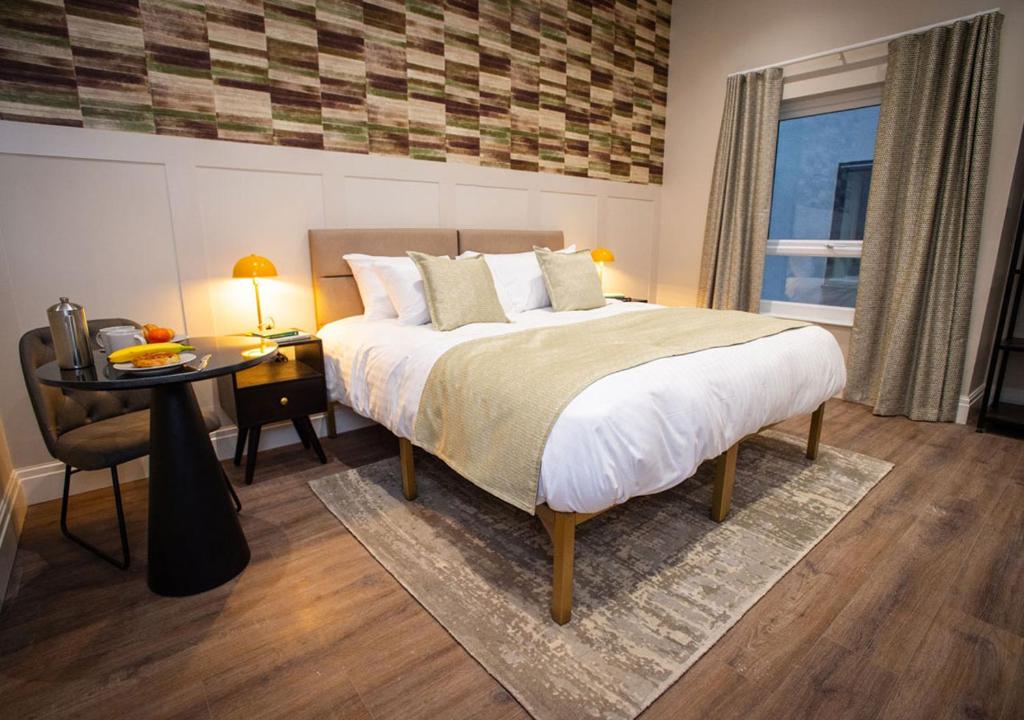 Postel nebo postele na pokoji v ubytování The Gresham Aparthotel