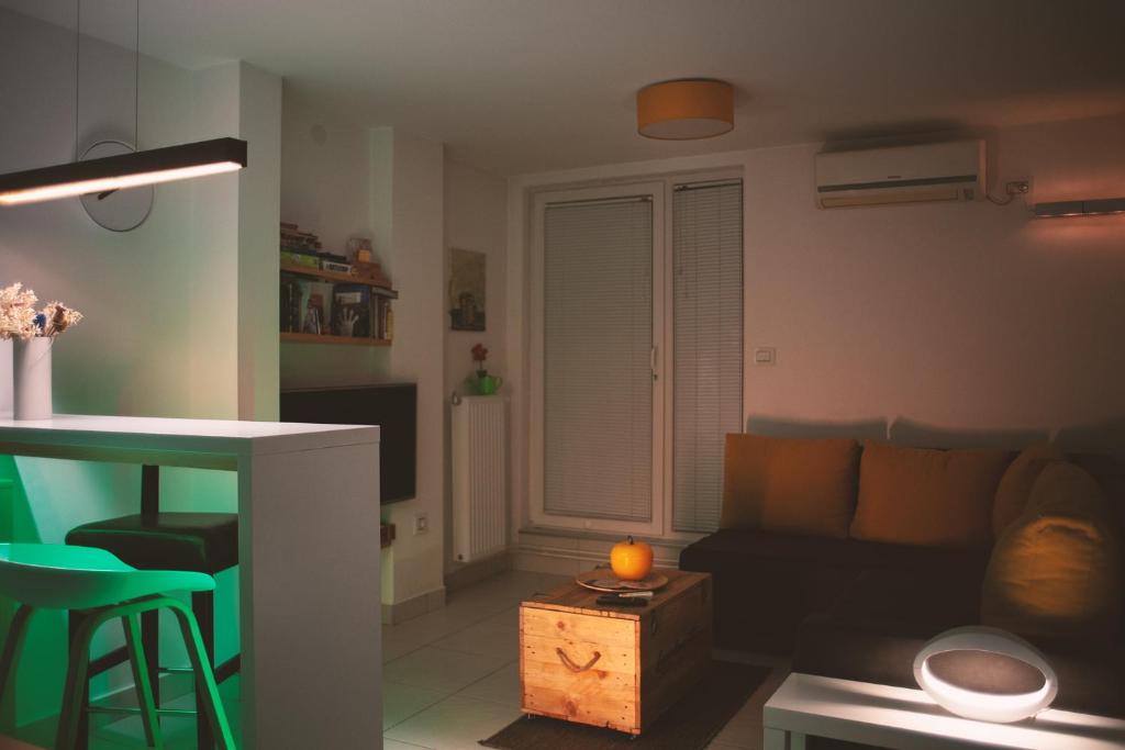 a living room with a couch and a table at The Best Guest Sunny Apartment By The River Free Public Parking in Niš