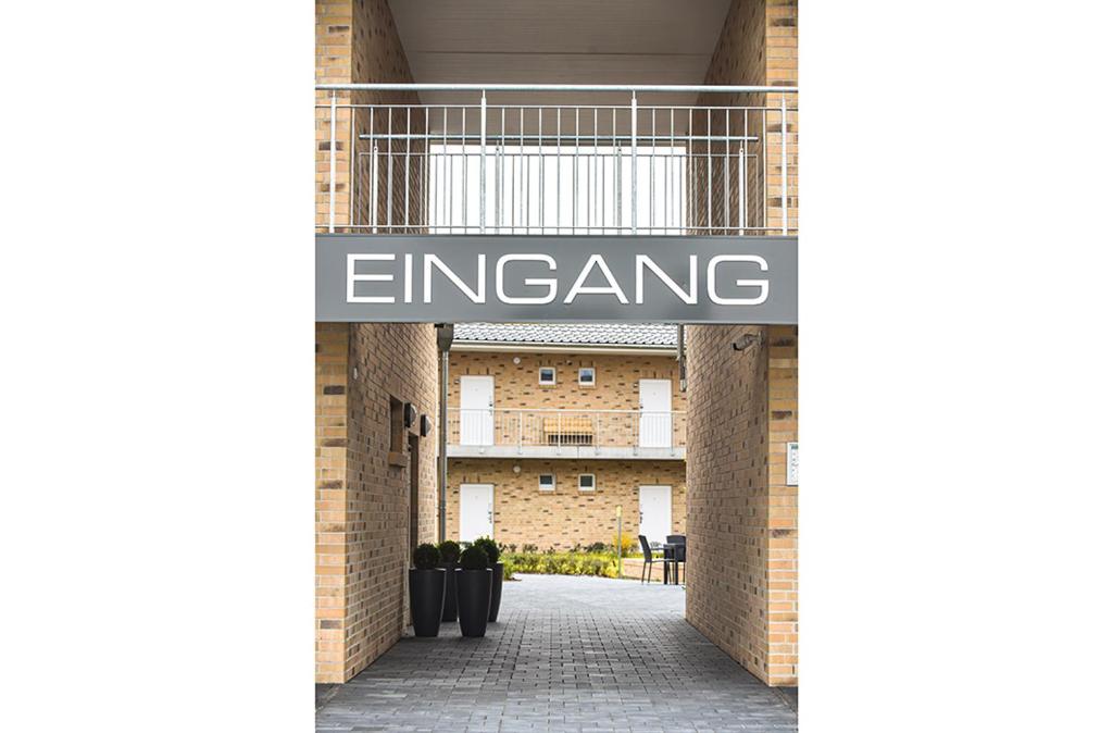 a building with a sign that reads entrance at PRIMA Inn HOTEL & HOF NEURUPPIN - digitales & rezeptionsloses Motel in Neuruppin