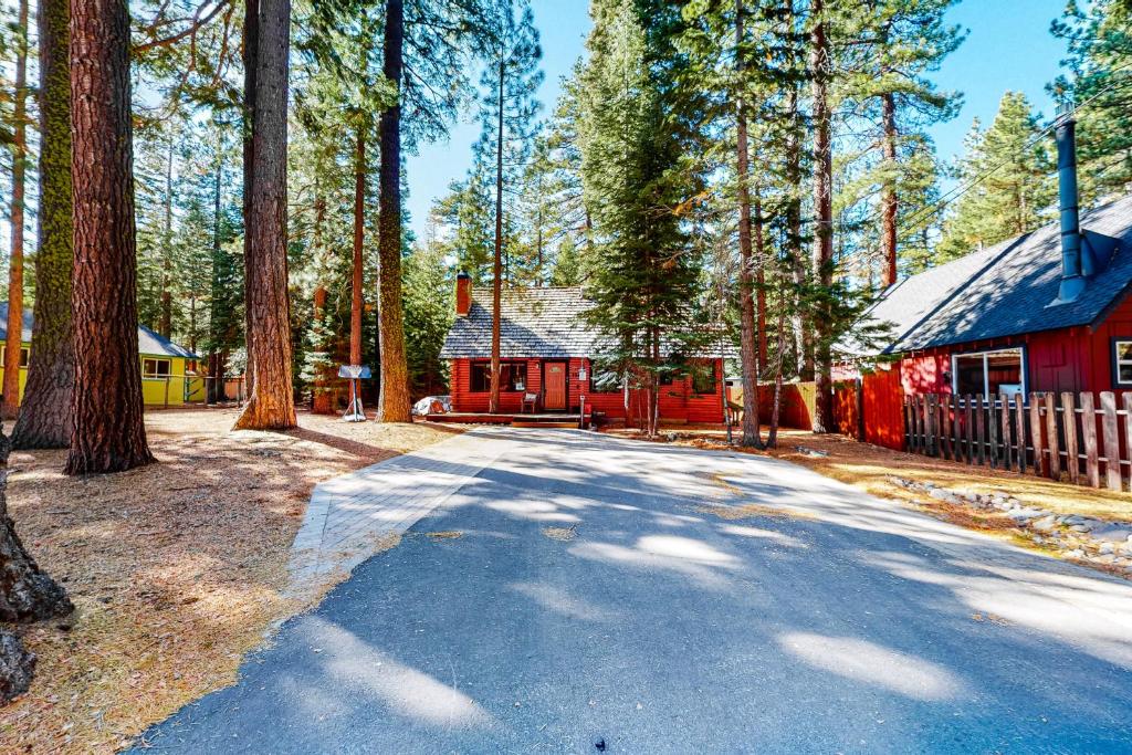a road in front of a red house with trees at Lake Tahoe Cabin Perfection in Tahoma