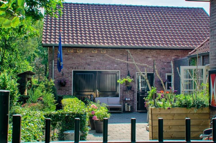 a brick house with a garden in front of it at Guesthouse Valkenswaard in Valkenswaard