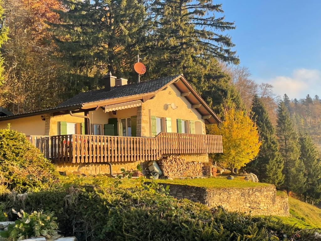 uma casa no topo de uma colina com árvores em Chalet chez Jules em Asuel