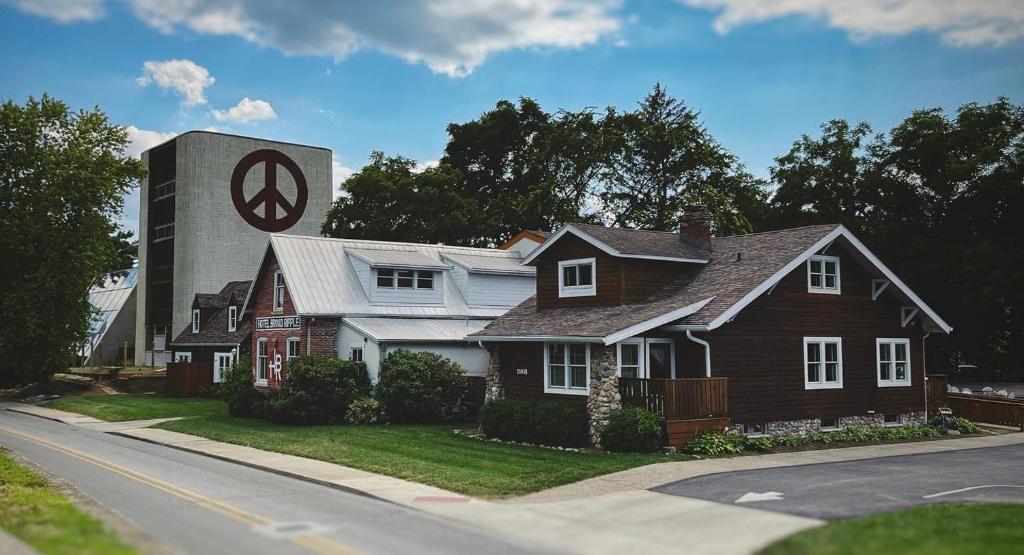 a house with a clock tower on the side of a street at Hotel Broad Ripple in Indianapolis