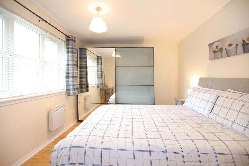 a bedroom with a bed and a large window at Edinburgh Palace Apartment in Edinburgh