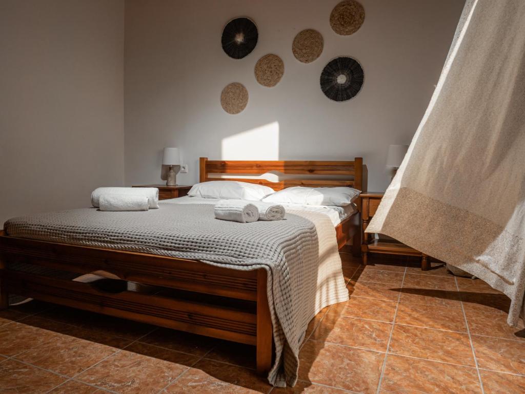 a bedroom with a bed with towels on it at Kaloudis family in Agios Georgios