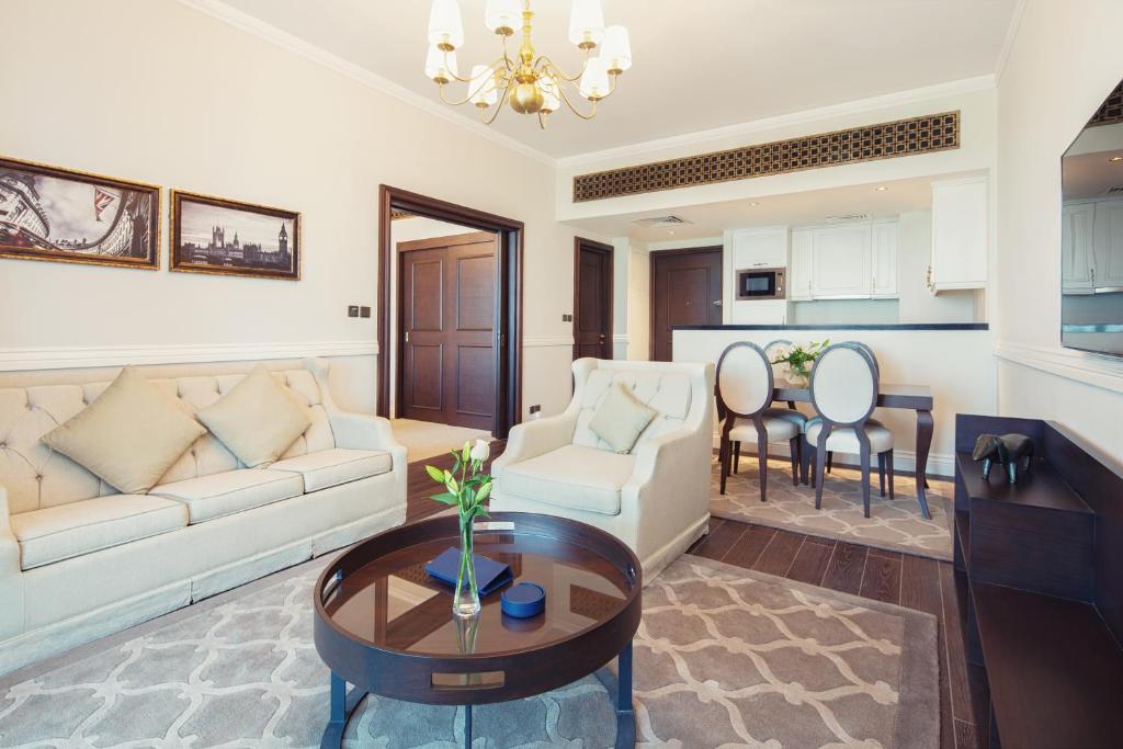 a living room with a couch and a table at Dukes The Palm Dubai Hotel in Dubai