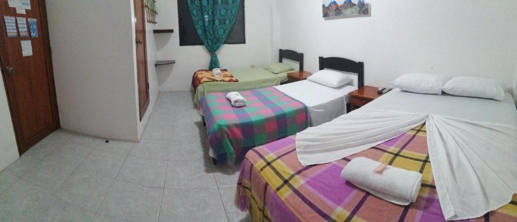 Postel nebo postele na pokoji v ubytování Hostal La Casa de Luis