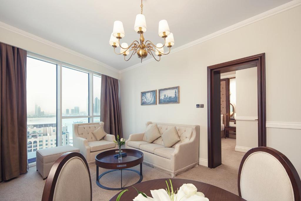 a living room with a couch and a table at Dukes The Palm Dubai Hotel in Dubai