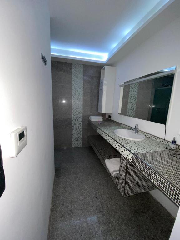 a bathroom with a sink and a mirror at Koliba apartments in Bratislava