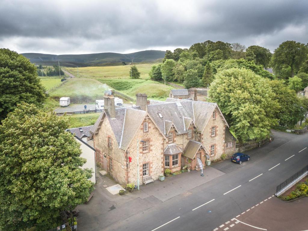 an aerial view of a large house with a road at The Hopetoun Arms Hotel in Leadhills