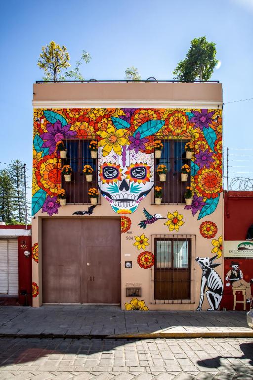 Hotel La Casa de Pino, a building with painted skulls and flowers on it at La Casa de Pino in Oaxaca City