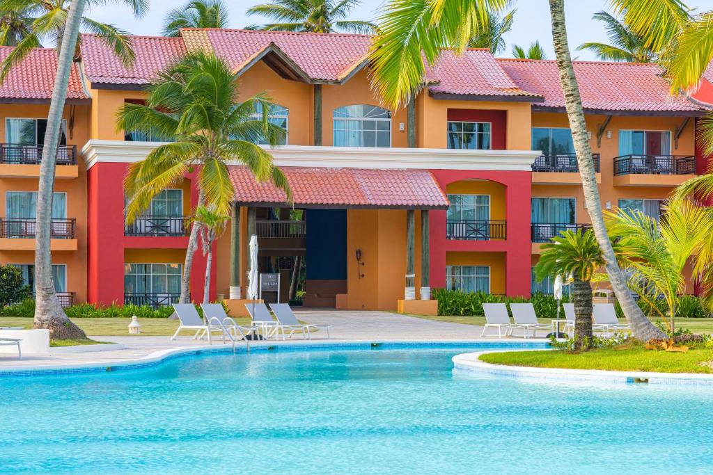 a resort with a swimming pool and palm trees at Punta Cana Princess Adults Only - All Inclusive in Punta Cana
