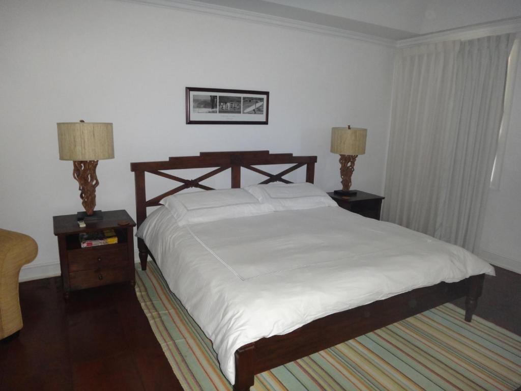 a bedroom with a bed and two nightstands and two lamps at The Atlantis Historic Inn in Saint Joseph