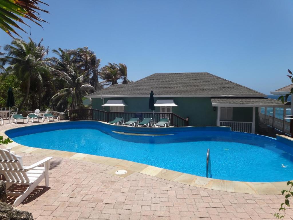 a swimming pool in front of a house at The Atlantis Historic Inn in Saint Joseph