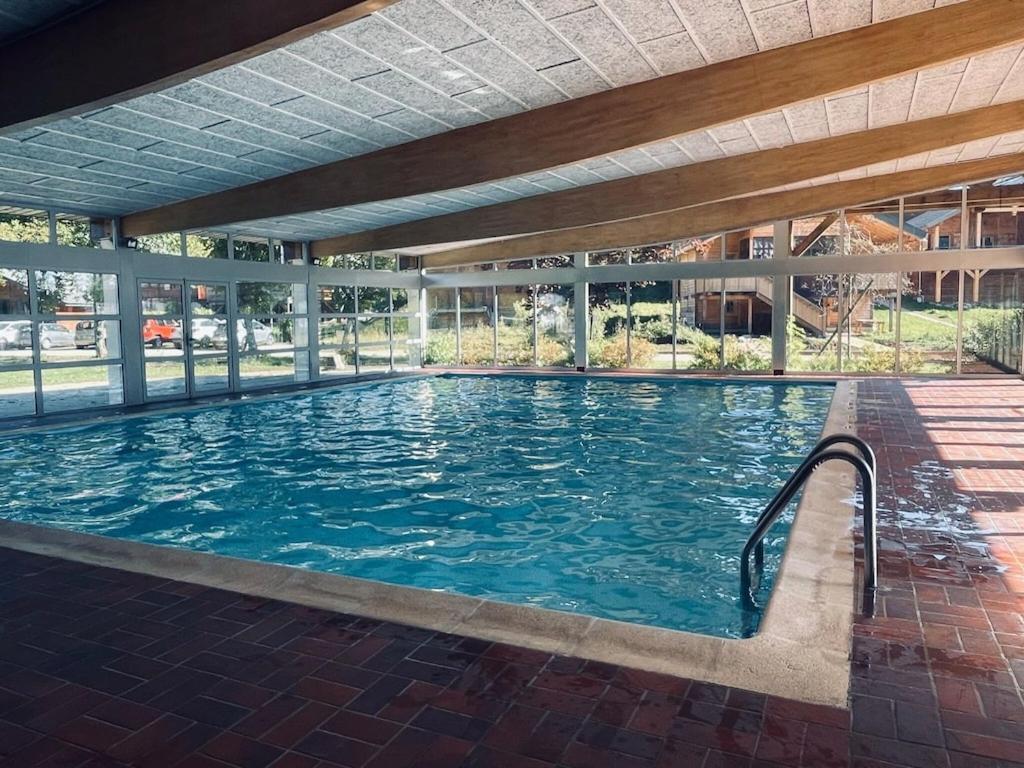 a large swimming pool in a building at Chalet in Saint Laurent on a slope in Saint-Laurent-du-Jura