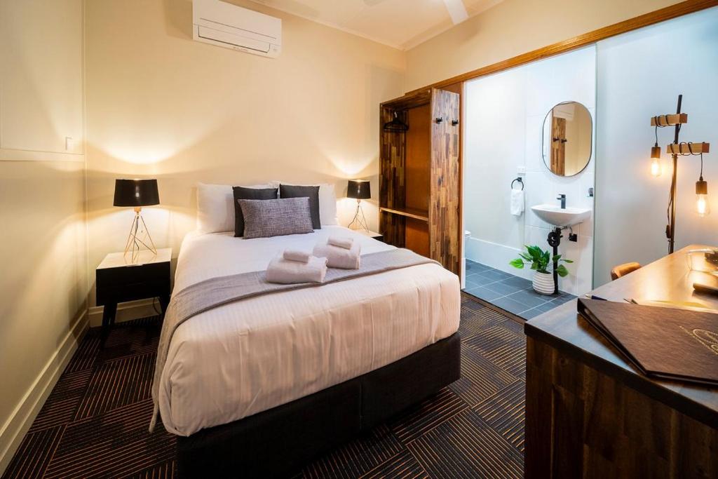 - une chambre avec un lit et une salle de bains pourvue d'un lavabo dans l'établissement Peddlars Rest, à Toogoolawah