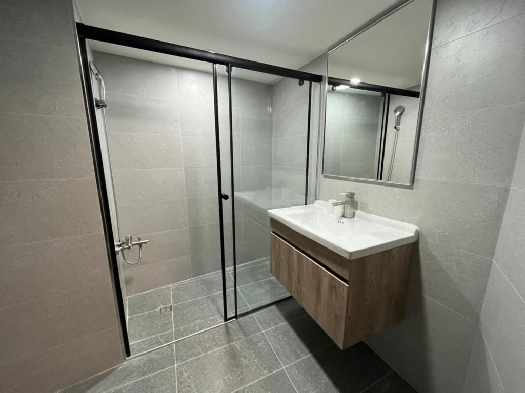 a bathroom with a sink and a shower at Yawan Hotel in Wenquan