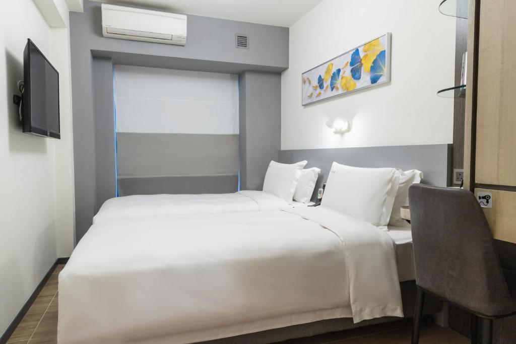 Postel nebo postele na pokoji v ubytování City Inn Macau