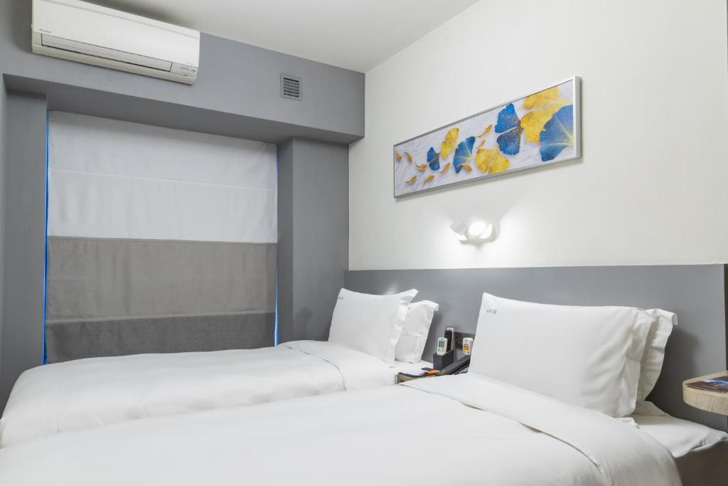 Postel nebo postele na pokoji v ubytování City Inn Macau
