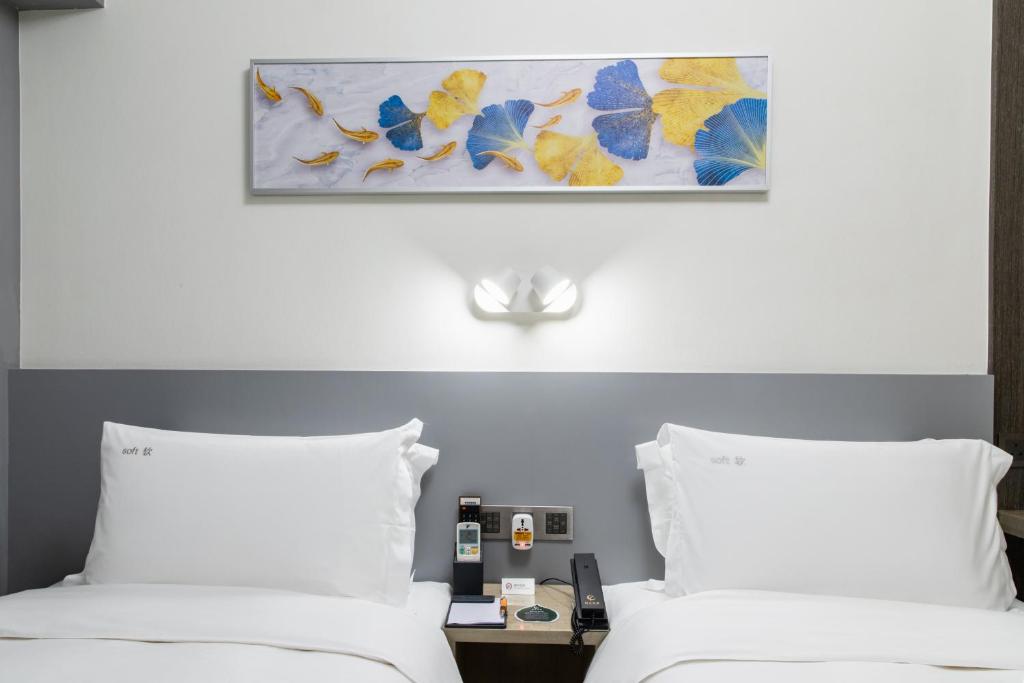 Ένα ή περισσότερα κρεβάτια σε δωμάτιο στο City Inn Macau
