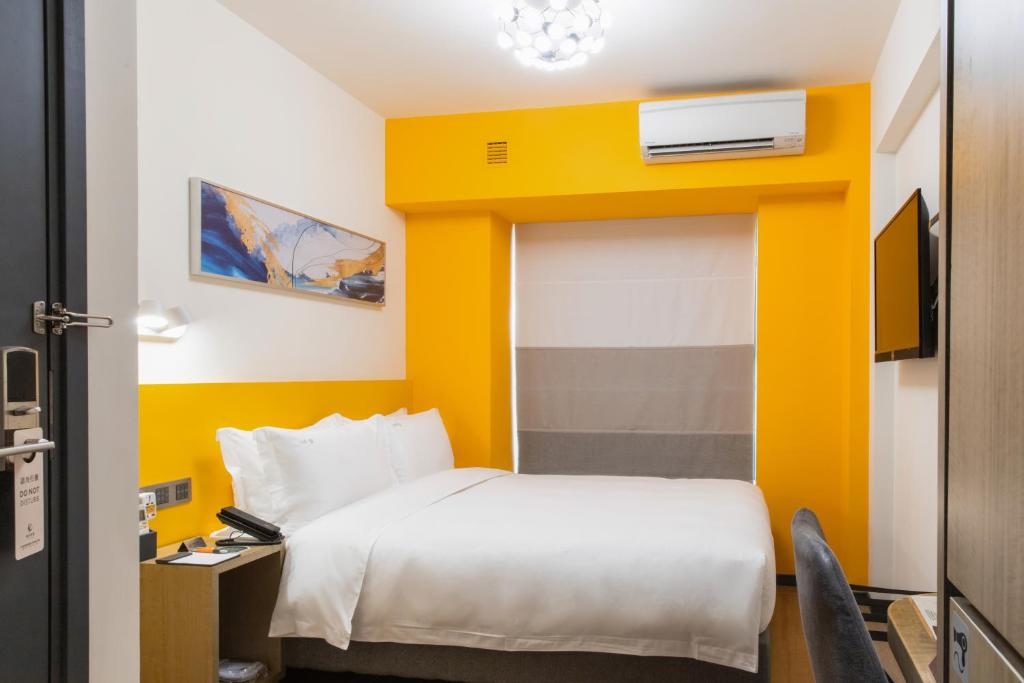Postel nebo postele na pokoji v ubytování City Inn Macau