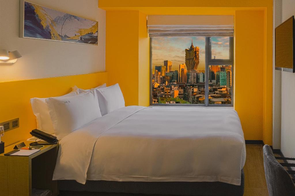 Postel nebo postele na pokoji v ubytování City Inn Macau